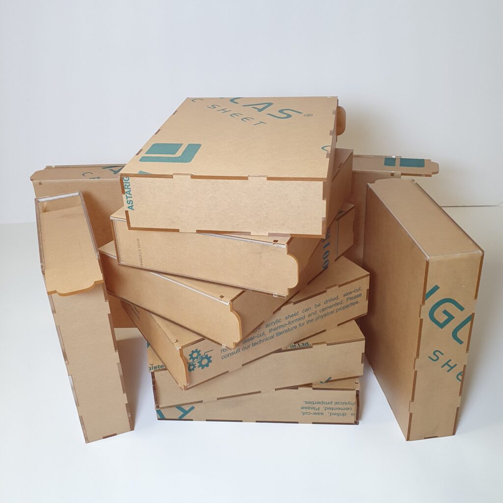 stack of acrylic boxes with protection paper on it.